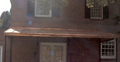 Copper standing seam roof panels on high-end residence